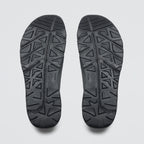 Black shoe sole with geometric pattern on a light gray background