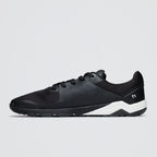 Black athletic shoe with white sole on a light gray background
