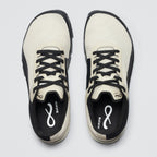Pair of white and black sneakers with visible brand logo on a light gray background