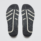 Black and white sole of a shoe on a light gray background